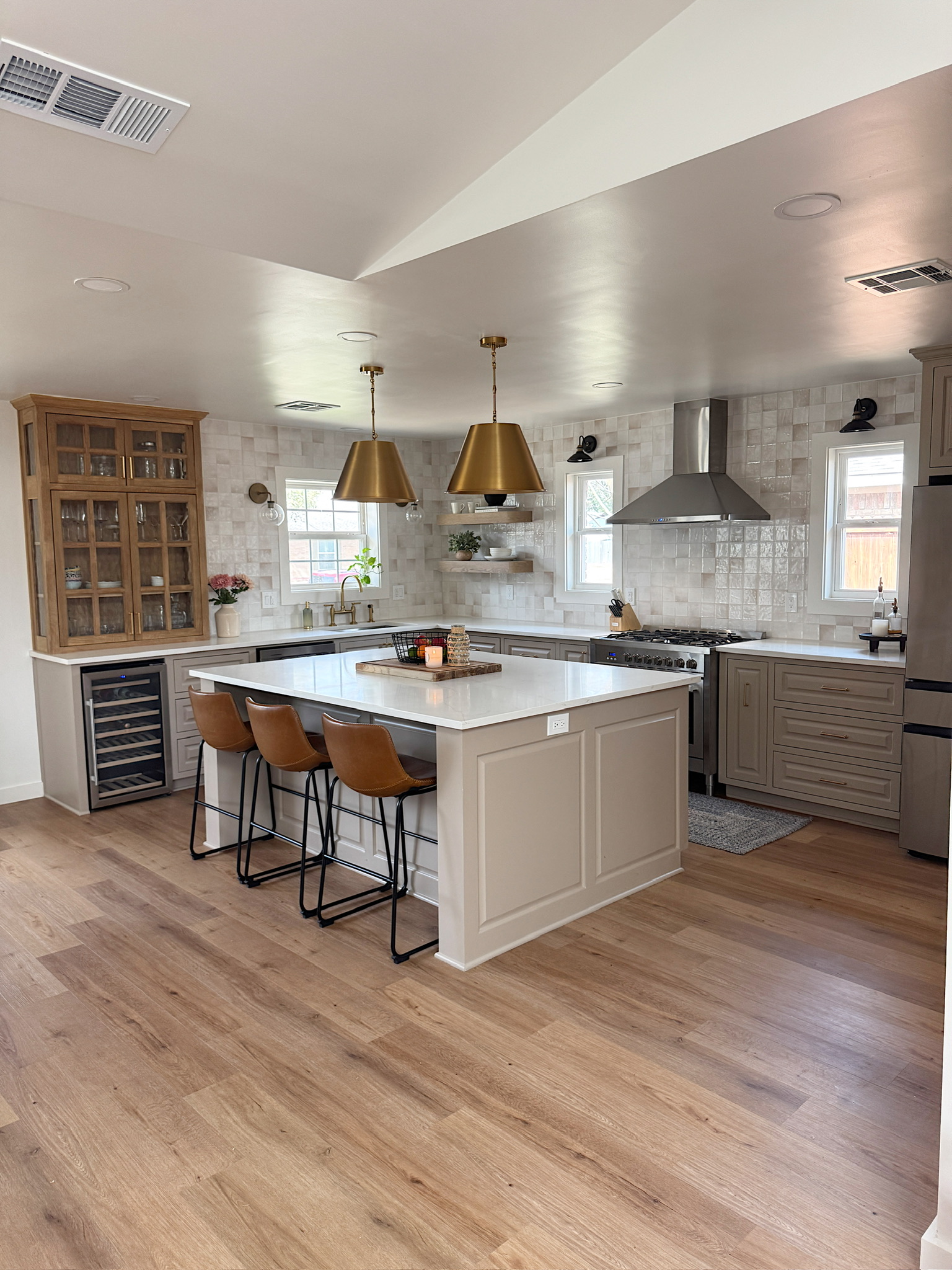 Completed renovation opening an older home into a connected kitchen, dining, and living space